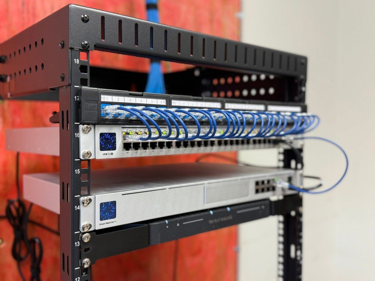 Arcomm-managed network rack with Ubiquiti equipment in a New Hampshire business